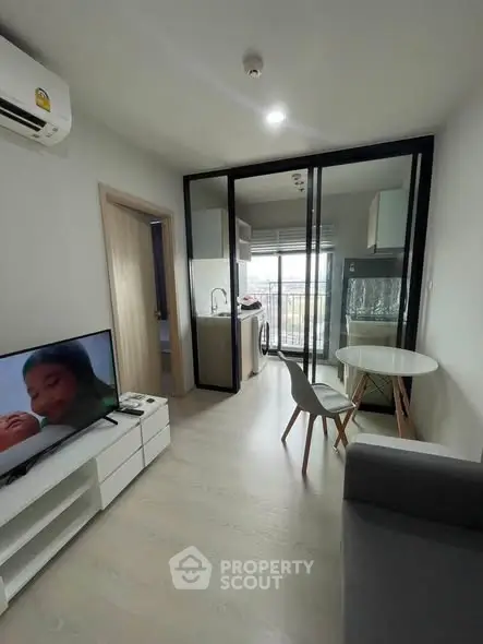 Modern apartment living room with open kitchen and balcony view