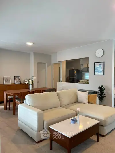 Spacious modern living room with elegant furniture and open layout, perfect for family gatherings.