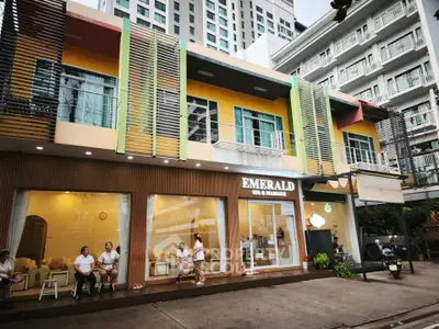 Modern commercial building with vibrant facade and spa signage in urban setting.