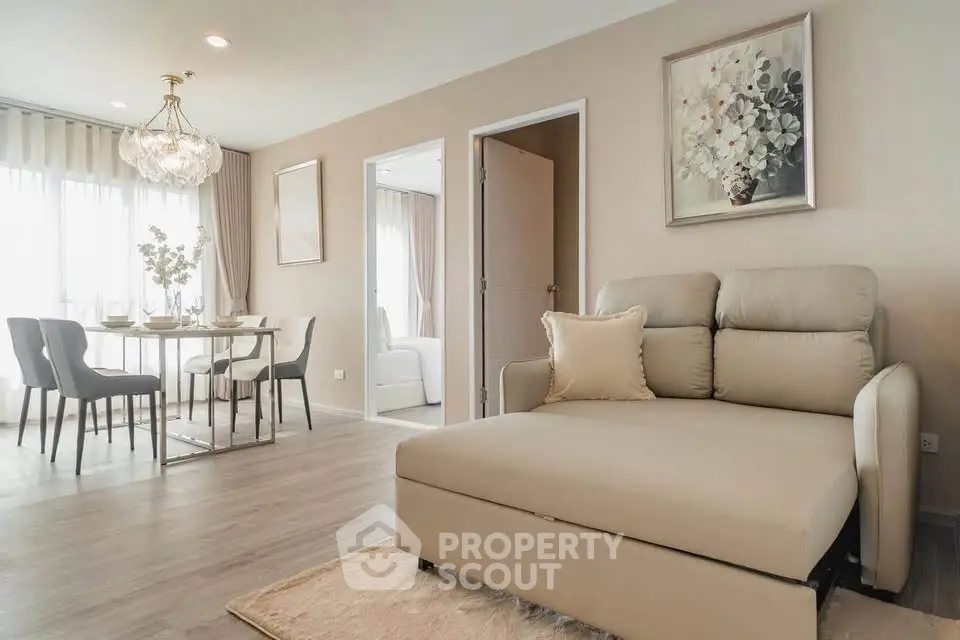 Elegant living room with modern decor and dining area, featuring plush seating and stylish lighting.