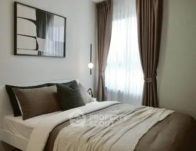 Cozy bedroom with modern decor and natural light through large windows.