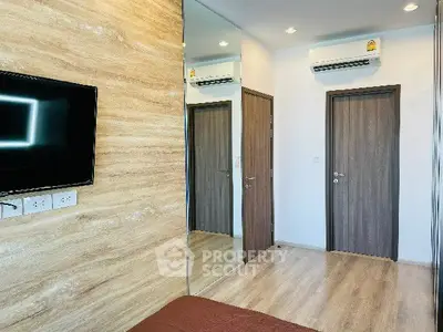 Modern bedroom with wooden accents and wall-mounted TV