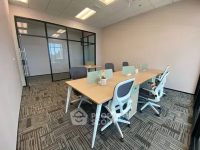 Modern office space with glass partitions and ergonomic chairs, ideal for productivity and collaboration.