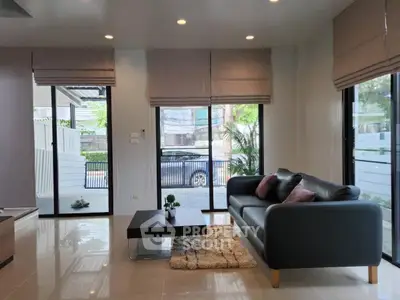 Spacious modern living room with large windows and stylish furniture