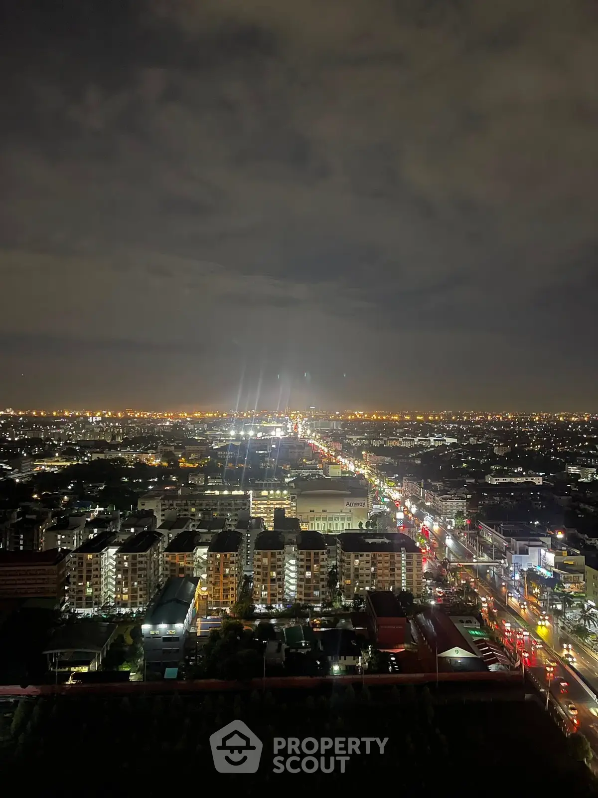 Stunning nighttime cityscape view from a high-rise building, showcasing vibrant city lights and urban landscape.