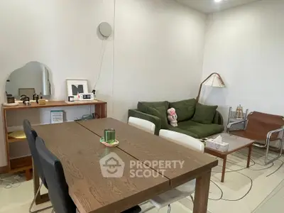 Stylish living room with modern furniture and cozy green sofa