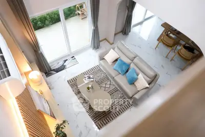 Spacious modern living room with elegant decor and large windows for natural light.