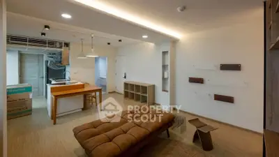Modern living room with stylish furniture and open kitchen layout in a contemporary apartment.