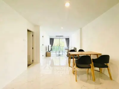 Spacious modern living room with elegant dining area and large windows for natural light.