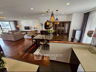 Spacious open-plan living room with elegant decor and large windows for natural light.