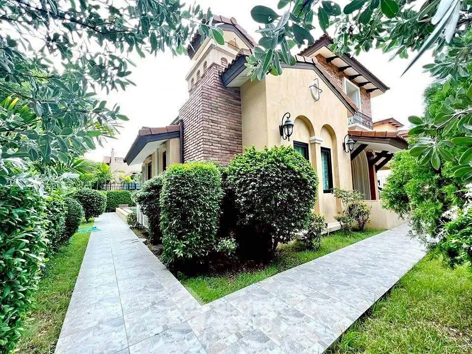 Charming villa with lush garden and elegant exterior design, perfect for serene living.
