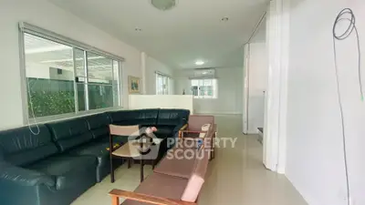 Spacious living room with modern furniture and large windows in a contemporary home.