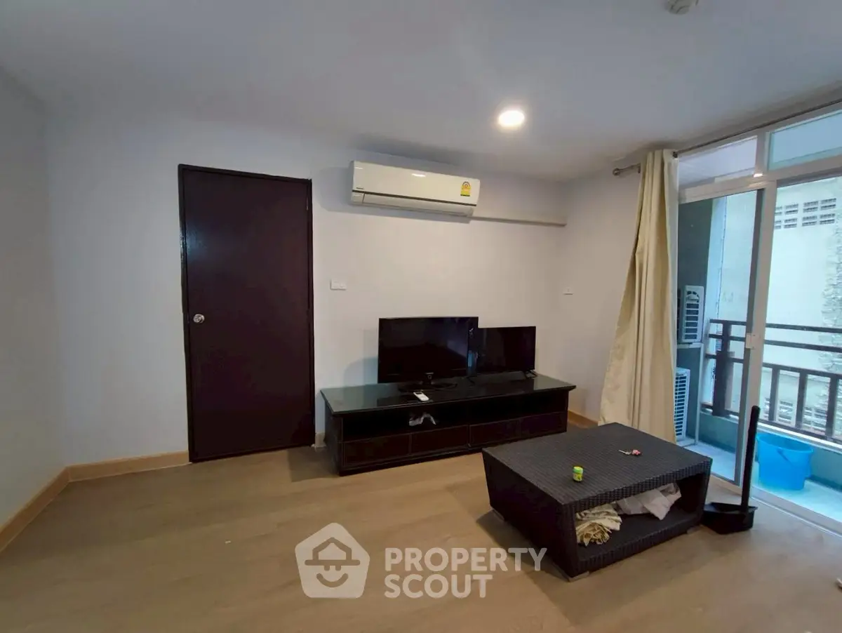 Modern living room with air conditioning and balcony access