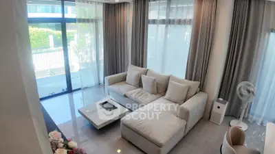 Spacious modern living room with large windows and elegant furnishings