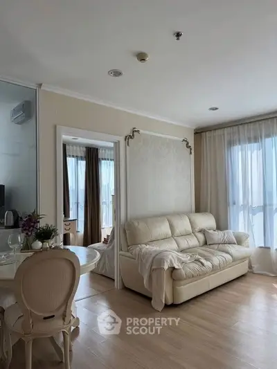 Elegant living room with cozy sofa and natural light, perfect for relaxation and comfort.