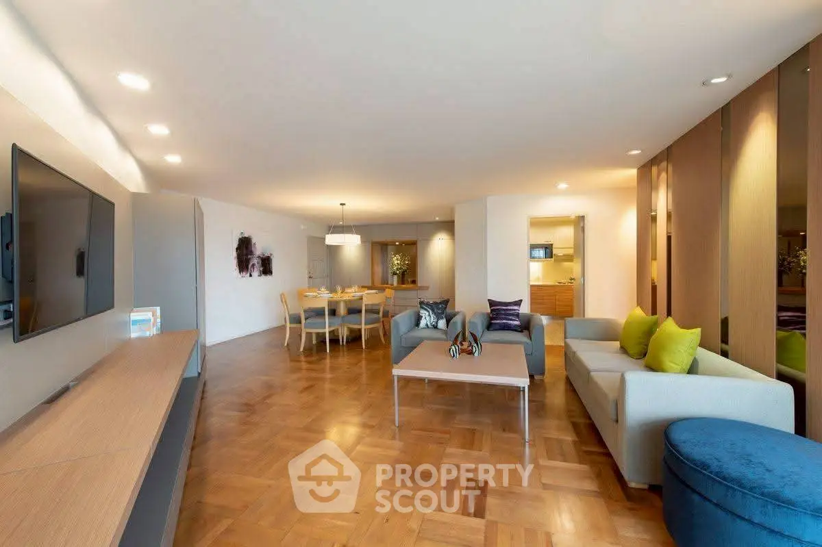 Spacious modern living room with elegant parquet flooring and stylish furniture, perfect for entertaining.