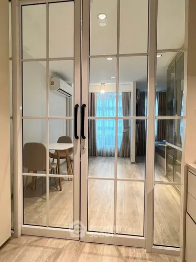 Modern living room with glass doors and elegant dining area