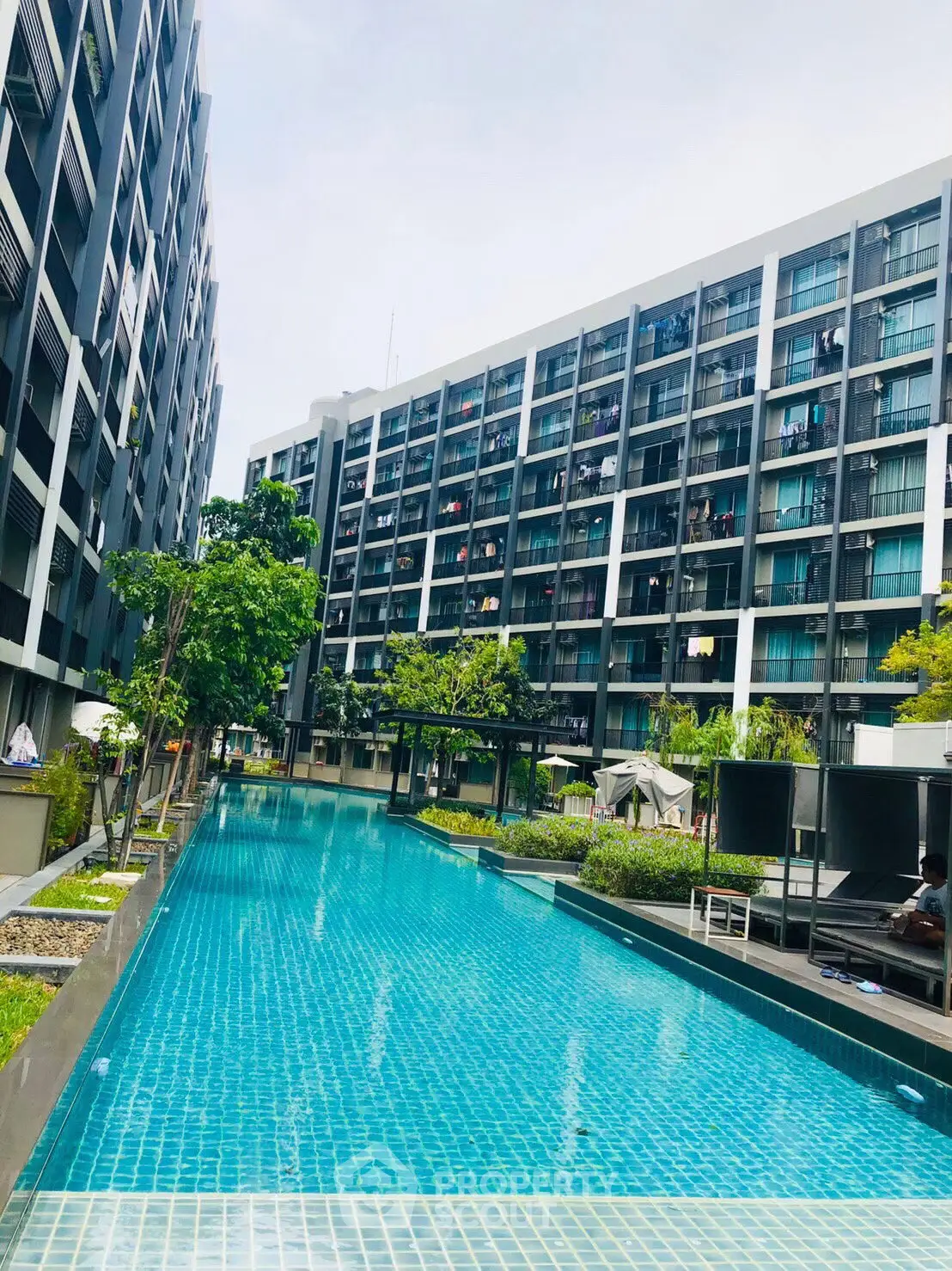 Luxurious condominium with stunning pool and modern architecture, perfect for urban living.