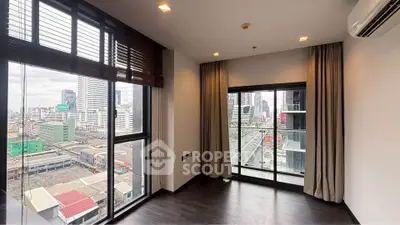 Modern corner unit with floor-to-ceiling windows offering stunning city views, perfect for urban living.
