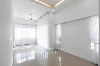 Spacious and bright living room with elegant curtains and modern lighting