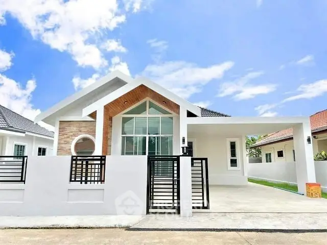 Modern single-story house with sleek design and spacious driveway