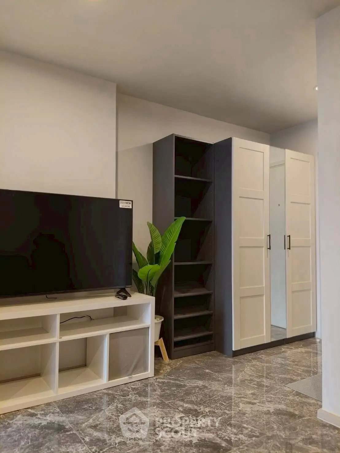 Modern living room with sleek TV stand and stylish storage solutions.