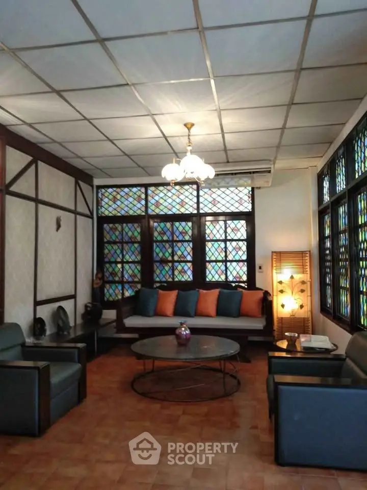 Charming living room with stained glass windows and cozy seating area