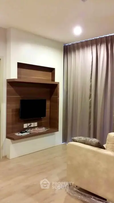 Modern living room with sleek TV setup and elegant curtains