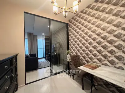 Stylish modern apartment with chic wallpaper and elegant lighting in a cozy living area.