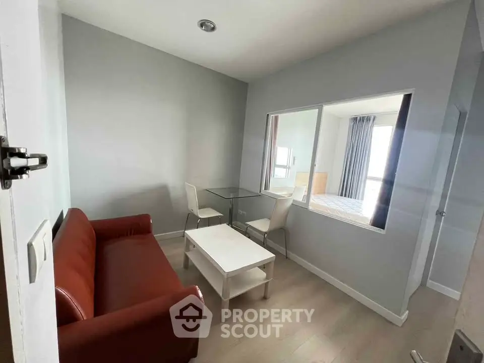 Cozy living room with modern furniture and large window for natural light