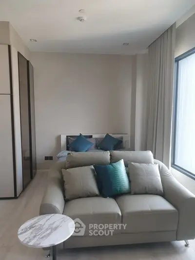 Modern studio apartment with cozy living area and stylish decor