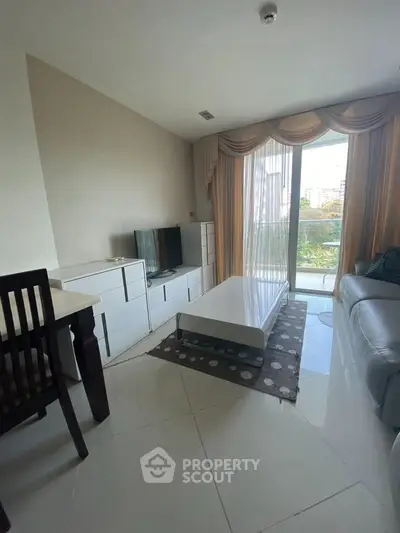 Modern living room with sleek furniture and large window view