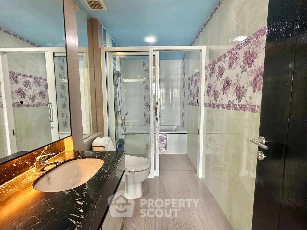 Luxurious bathroom with floral accents and modern fixtures