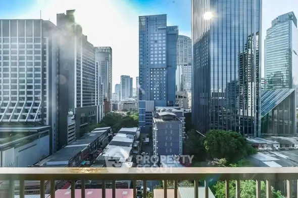 Stunning cityscape view from a high-rise balcony overlooking modern skyscrapers and urban landscape.