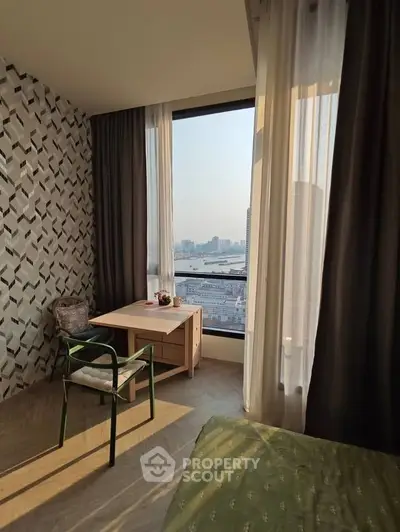 Chic bedroom with stunning city view, modern decor, and natural light.