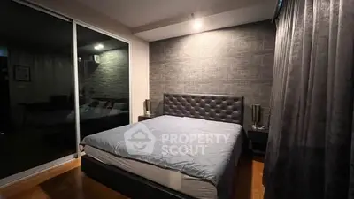 Modern bedroom with stylish decor and large window