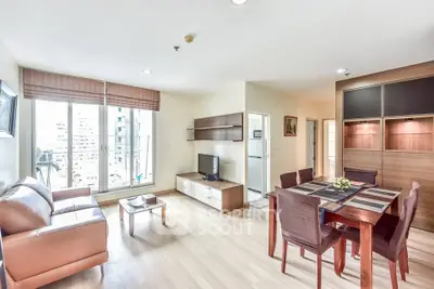 Spacious modern living room with dining area and large windows in a stylish apartment.