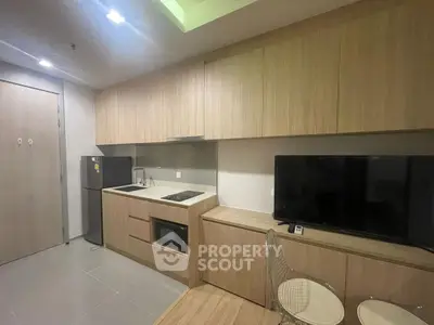 Modern kitchen with sleek cabinetry and integrated appliances in a stylish apartment.