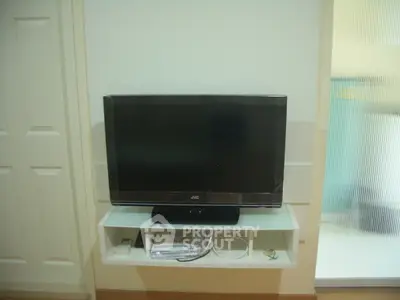 Modern living room with sleek TV setup and minimalist shelving