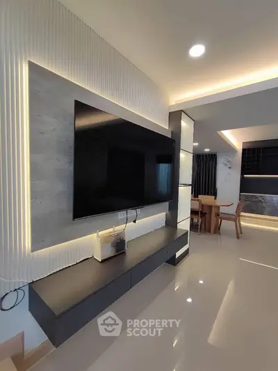 Modern living room with sleek TV unit and elegant dining area