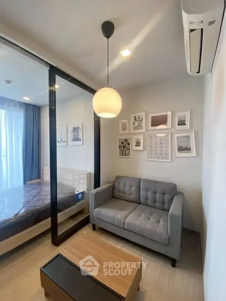 Modern living room with cozy sofa and stylish decor adjacent to a bedroom.