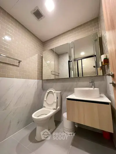 Modern bathroom with sleek design, featuring a stylish vanity and contemporary fixtures.