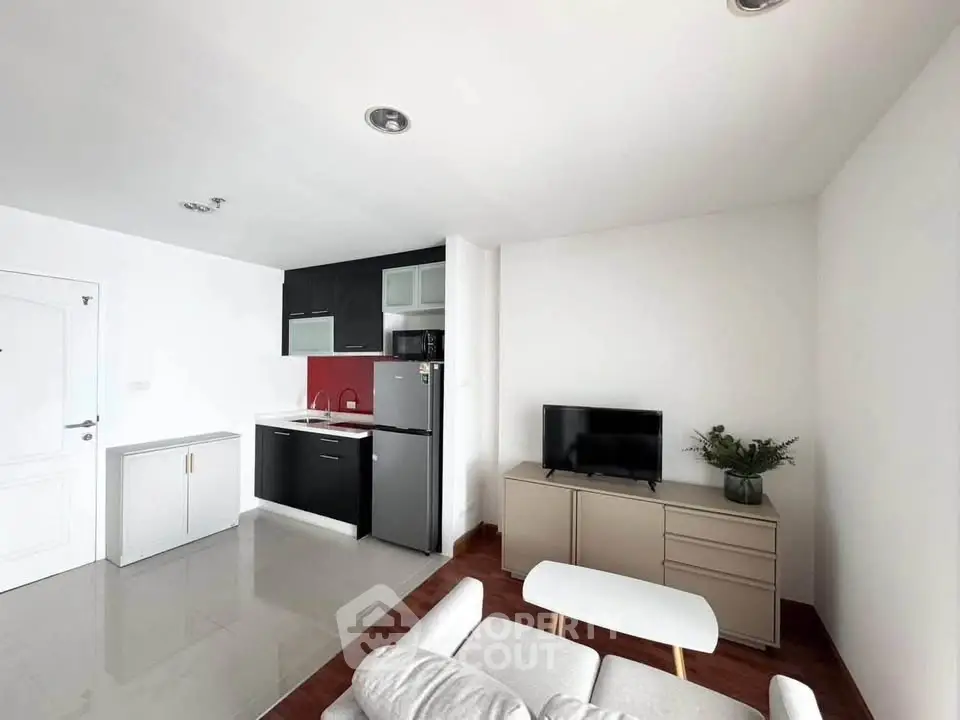 Modern living room with sleek kitchen, stylish furniture, and contemporary design in open layout apartment.