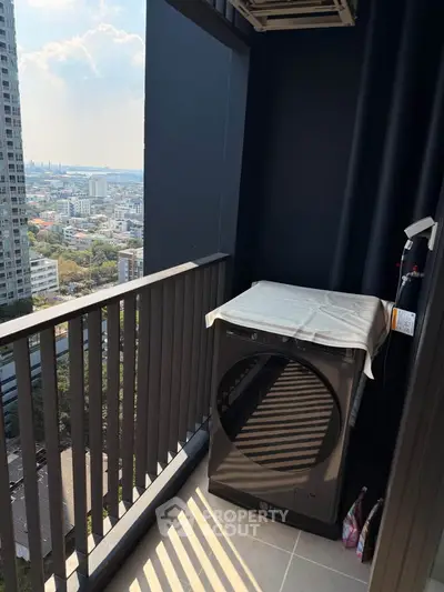 High-rise balcony with city view and modern washing machine, perfect for urban living.