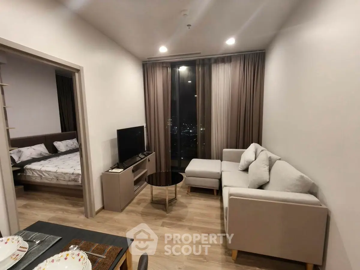 Modern living room with cozy sofa and city view, adjacent to stylish bedroom