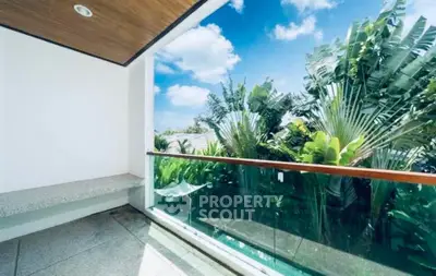 Stunning balcony with lush greenery and clear blue sky view, perfect for relaxation.