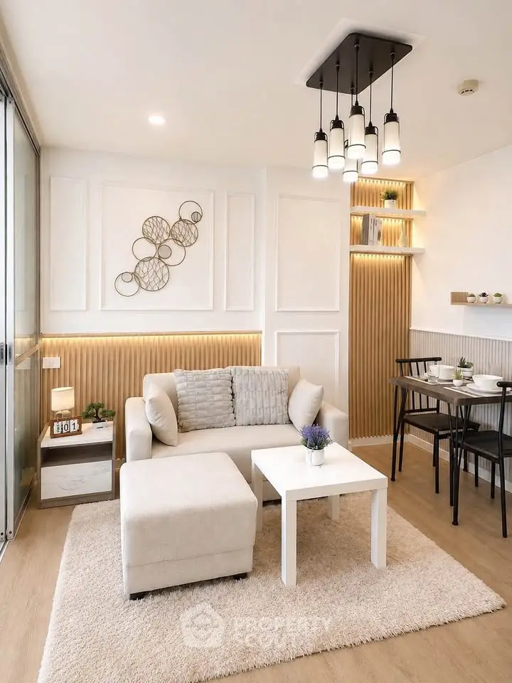 Modern living room with elegant decor and cozy seating area, featuring stylish lighting and a dining nook.