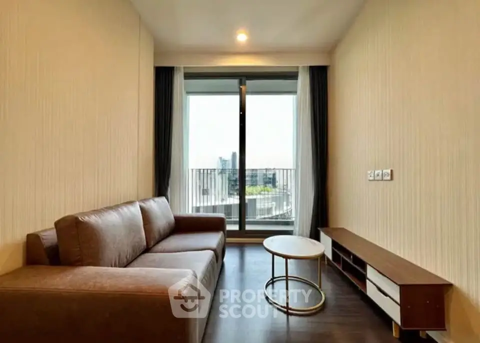 Modern living room with large window and city view, featuring a sleek sofa and stylish coffee table.