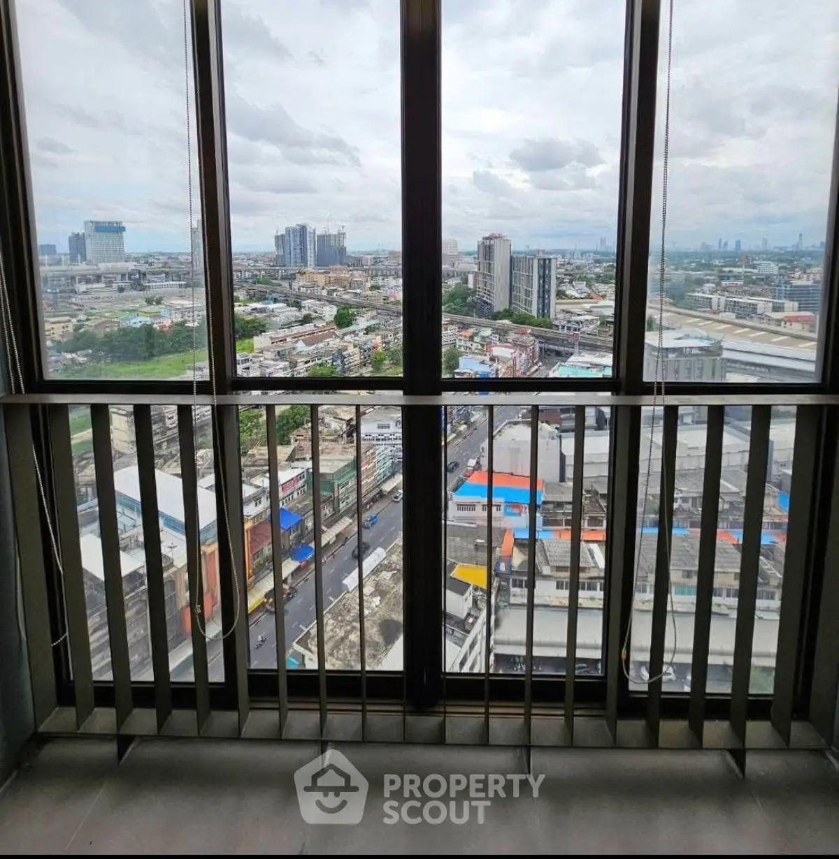 Stunning high-rise balcony view overlooking cityscape with expansive skyline and urban landscape.