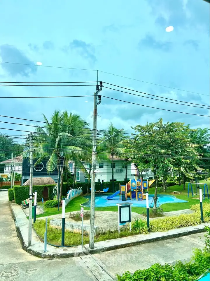 Charming residential community with lush greenery and a vibrant playground, perfect for family living.
